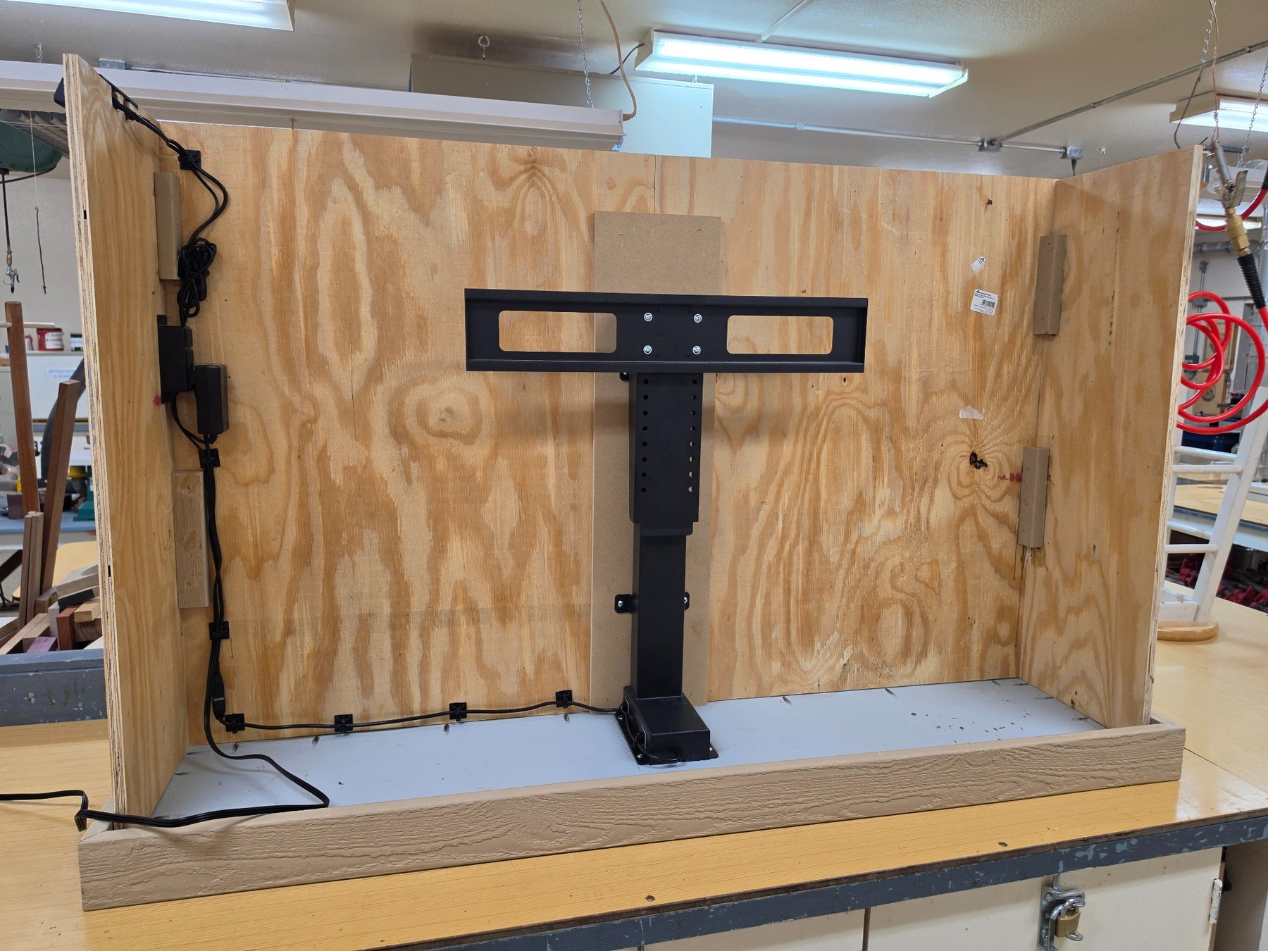 TV lift system installed inside cabinet frame