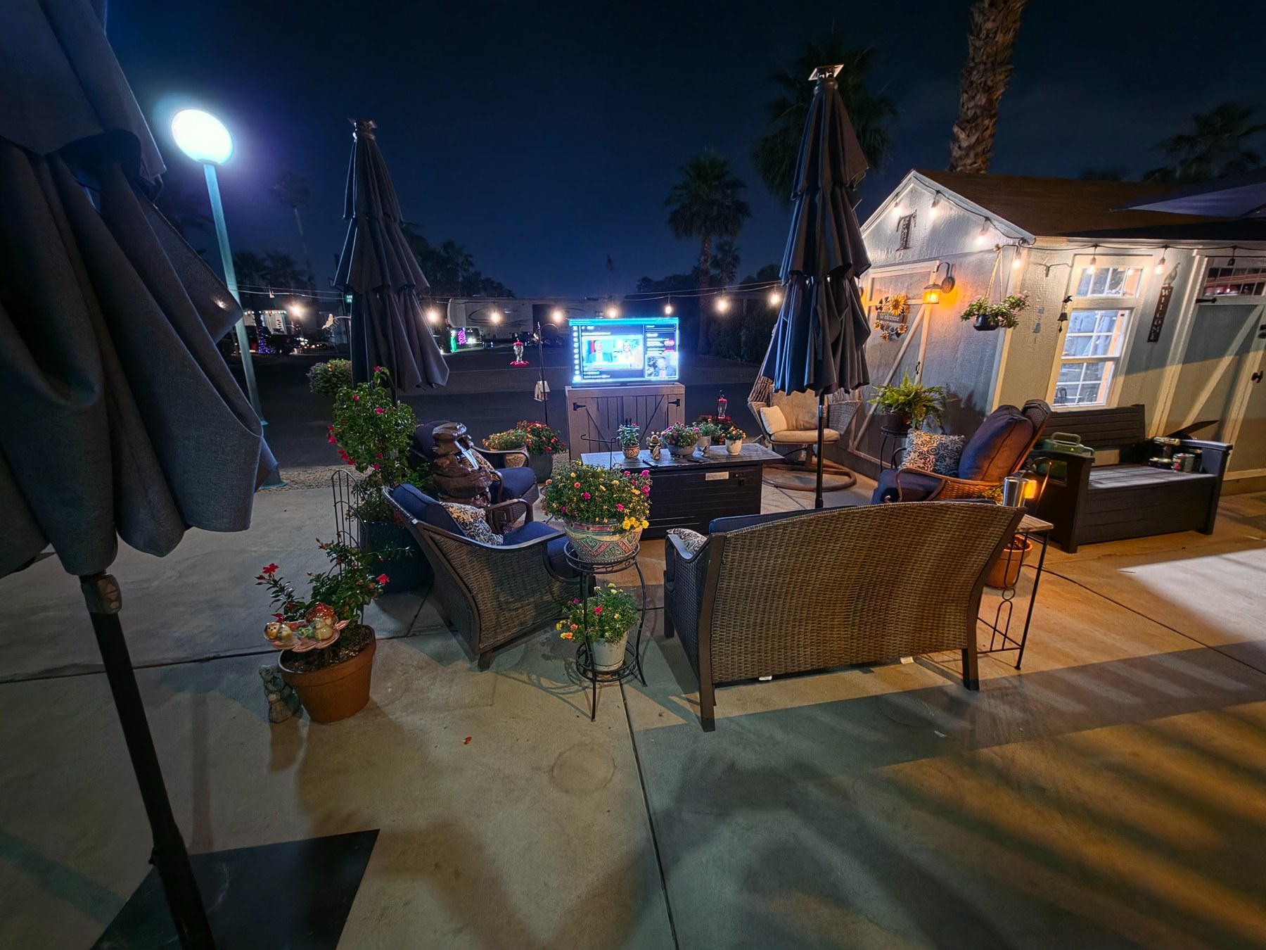 Outdoor TV cabinet nighttime patio setup