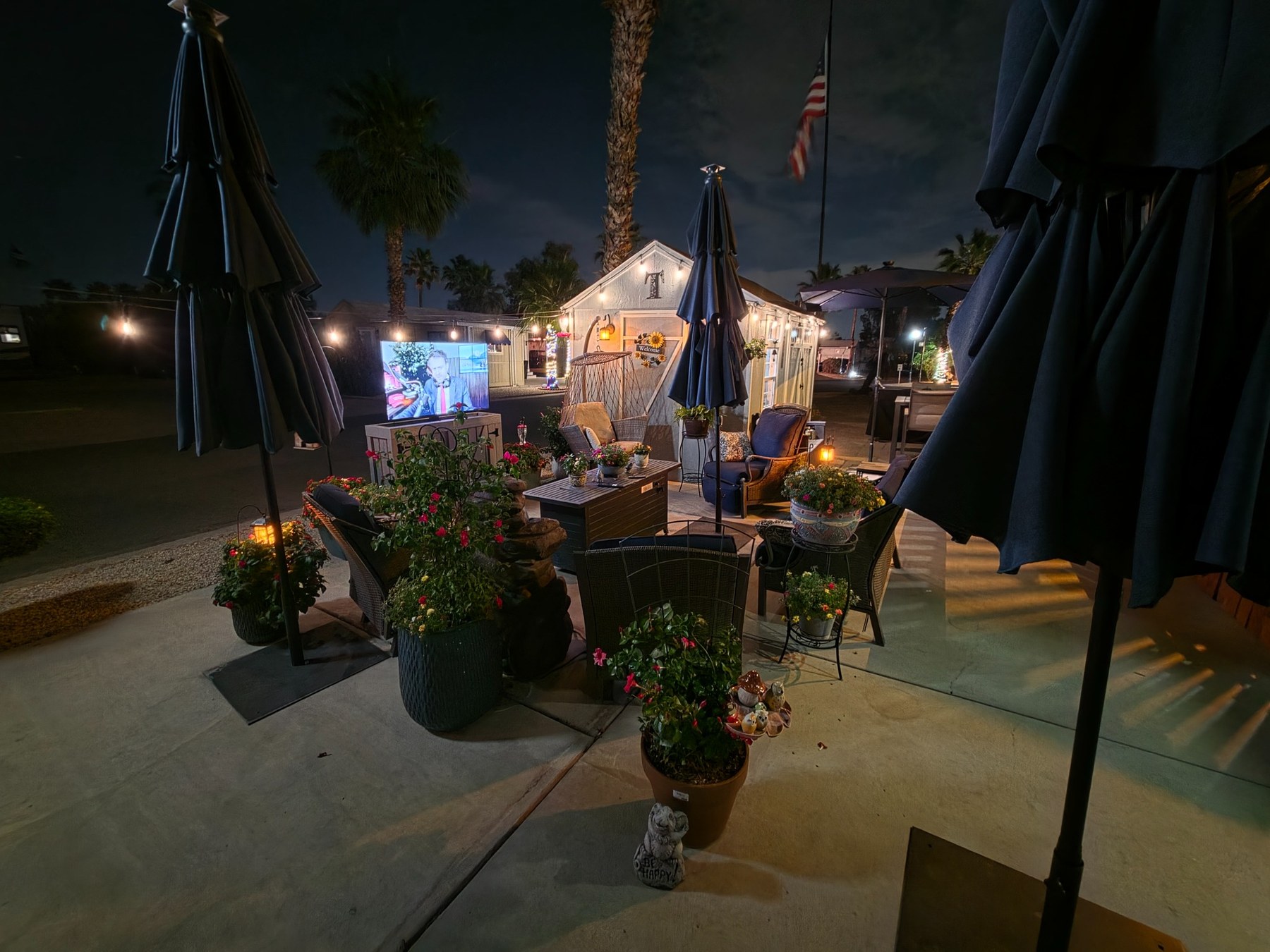 Outdoor TV cabinet in a patio setup at night