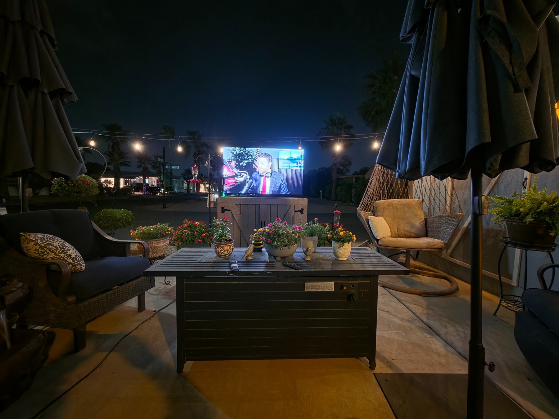 Outdoor TV cabinet centered in patio seating area